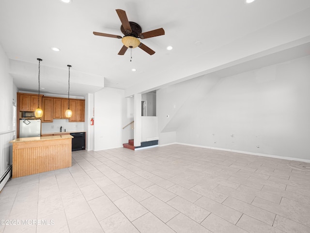 unfurnished living room featuring ceiling fan and sink