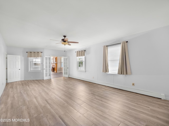 unfurnished living room with ceiling fan and light wood-type flooring