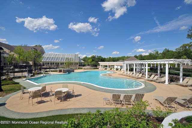 view of pool with a pergola and a patio