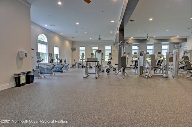 gym featuring ceiling fan and plenty of natural light