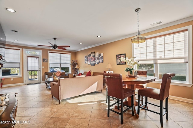 dining space with ceiling fan, light tile patterned floors, and crown molding