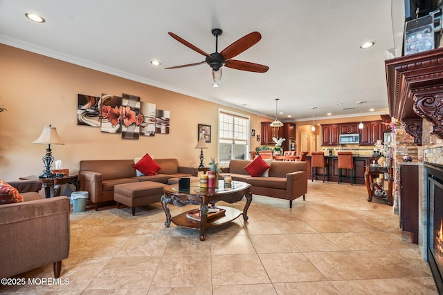 living room with ceiling fan and crown molding