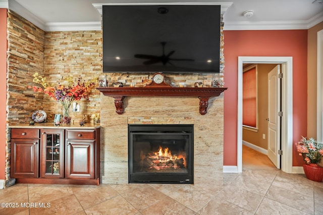 unfurnished living room with indoor bar, crown molding, and a fireplace