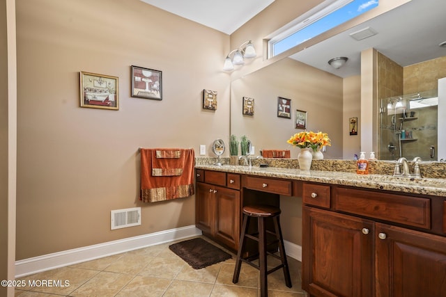 bathroom featuring tile patterned flooring, a shower with door, and vanity