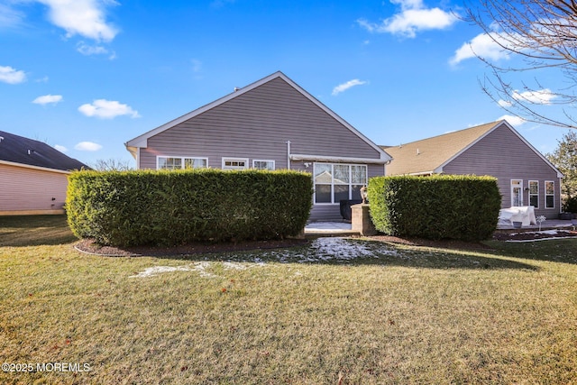 back of property featuring a lawn