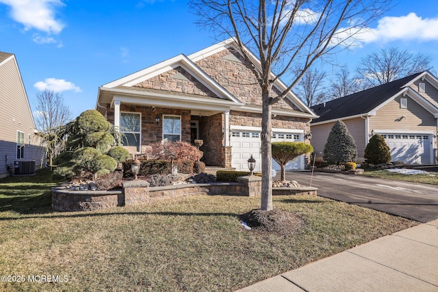 view of front of property featuring covered porch, a front yard, a garage, and central AC