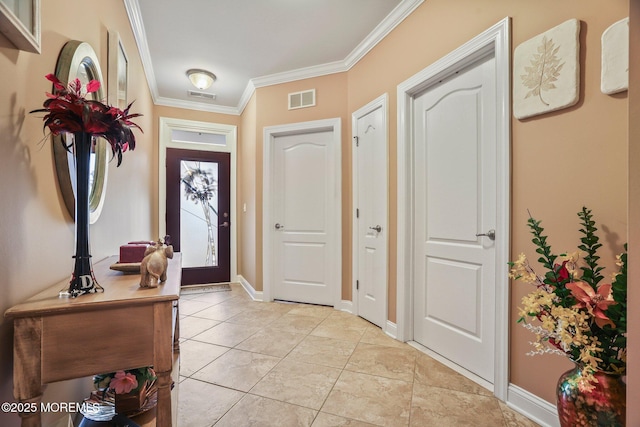 tiled entryway featuring ornamental molding