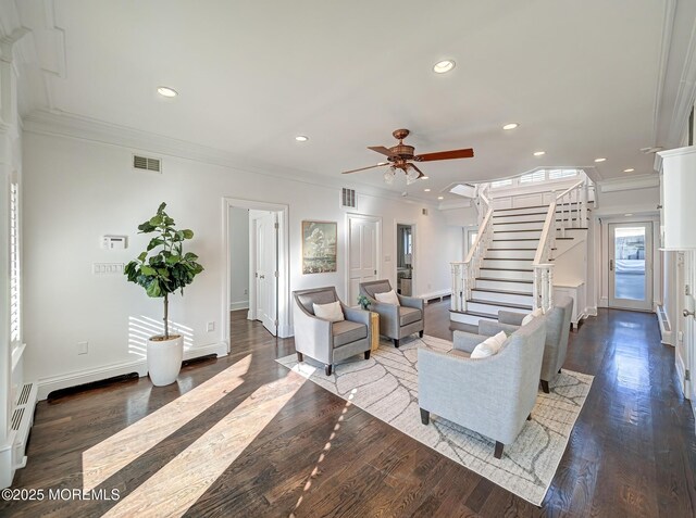 living room with ceiling fan, a baseboard radiator, crown molding, and hardwood / wood-style flooring