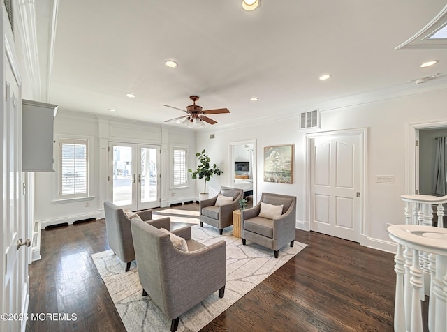 living room featuring dark wood-type flooring, ceiling fan, french doors, and crown molding