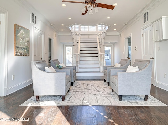 living room featuring ceiling fan, crown molding, and wood-type flooring