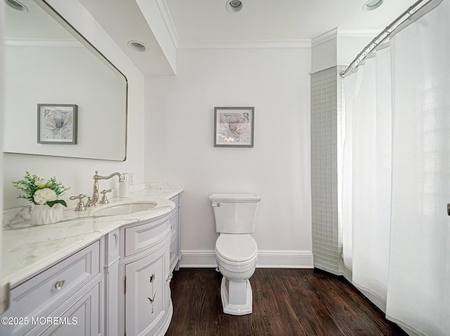 bathroom with hardwood / wood-style floors, toilet, walk in shower, vanity, and ornamental molding