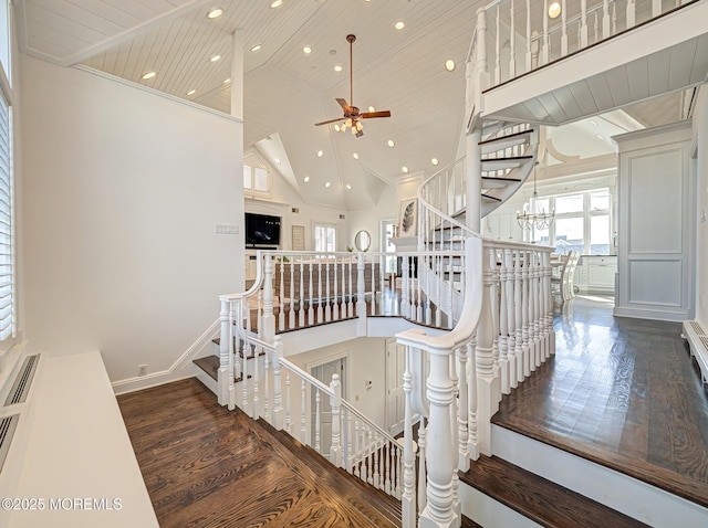 stairway featuring high vaulted ceiling, wood-type flooring, ceiling fan, and wood ceiling