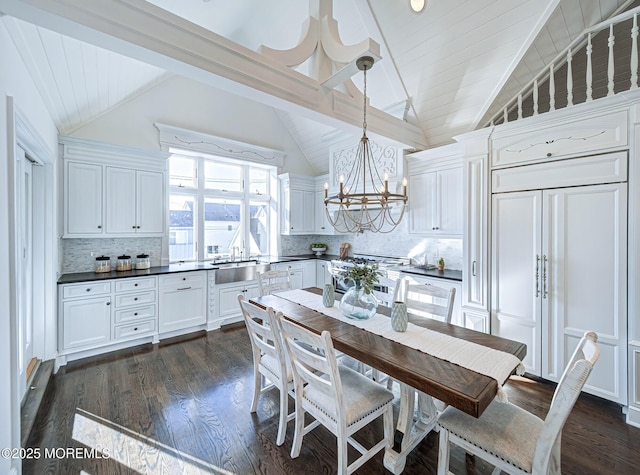 kitchen with dark hardwood / wood-style flooring, white cabinets, decorative backsplash, and hanging light fixtures