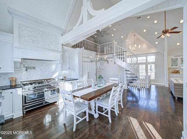 dining room with dark wood-type flooring, high vaulted ceiling, and ceiling fan