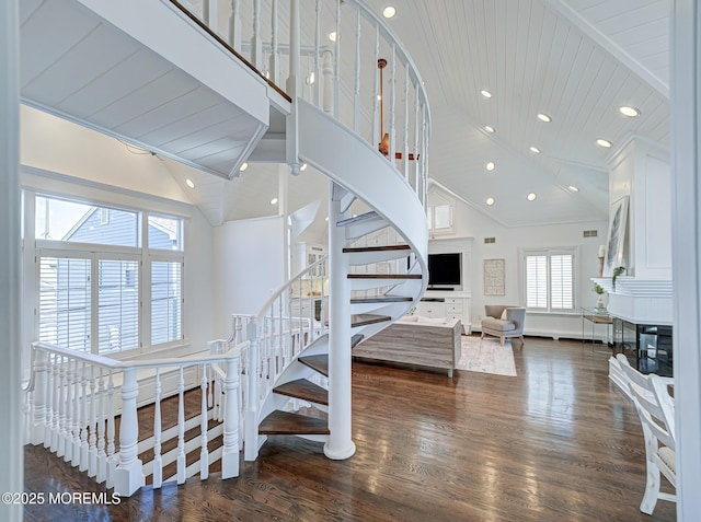 stairway with hardwood / wood-style flooring, high vaulted ceiling, and wood ceiling