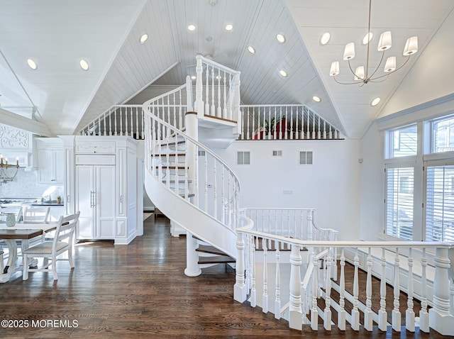 stairs featuring an inviting chandelier, wooden ceiling, high vaulted ceiling, and wood-type flooring