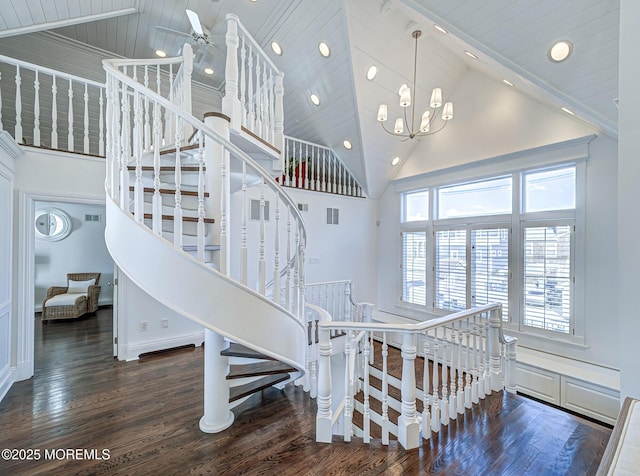 stairway featuring high vaulted ceiling and wood-type flooring