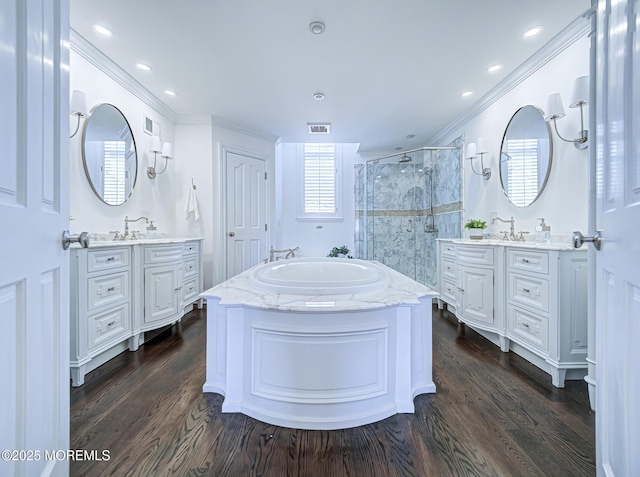 bathroom with vanity, hardwood / wood-style flooring, crown molding, and plus walk in shower