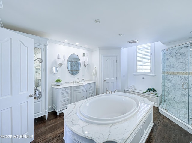 bathroom with shower with separate bathtub, wood-type flooring, and vanity