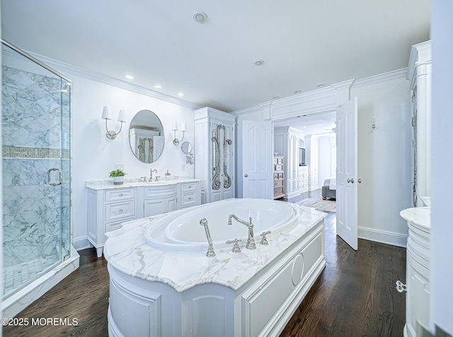 bathroom with ornamental molding, plus walk in shower, wood-type flooring, and vanity