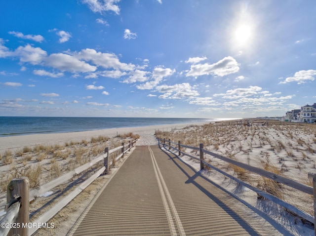 view of property's community with a beach view and a water view