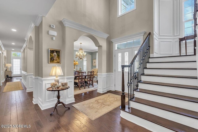 entryway featuring a chandelier, crown molding, and dark hardwood / wood-style flooring