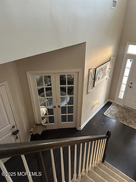 foyer entrance with french doors and hardwood / wood-style flooring