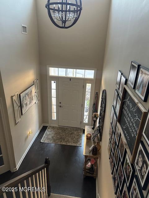 foyer featuring hardwood / wood-style flooring and a high ceiling