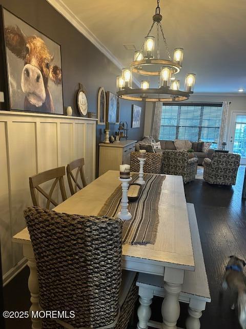 dining space with ornamental molding and dark wood-type flooring