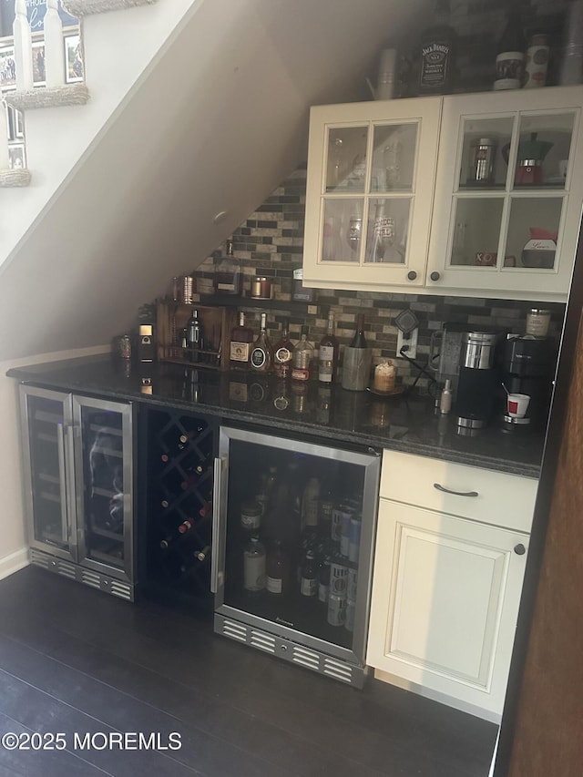 bar with vaulted ceiling, dark hardwood / wood-style floors, tasteful backsplash, white cabinets, and wine cooler