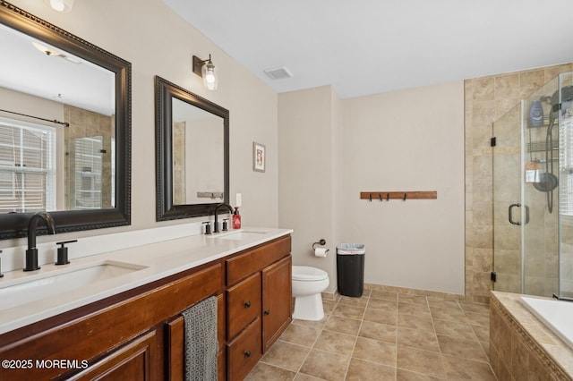 full bathroom featuring toilet, vanity, independent shower and bath, and tile patterned flooring