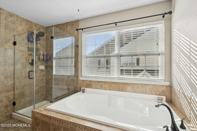 bathroom featuring separate shower and tub