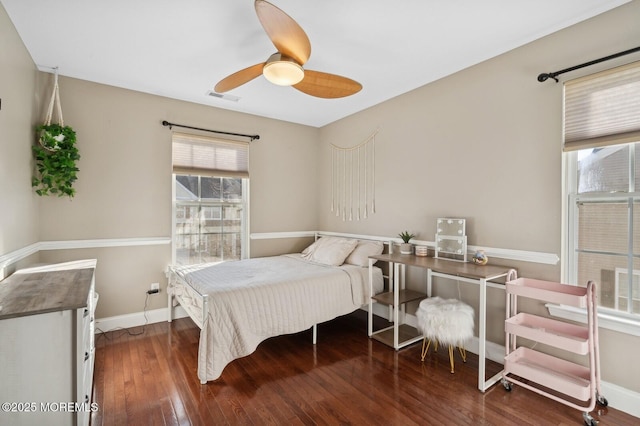 bedroom with ceiling fan and dark wood-type flooring