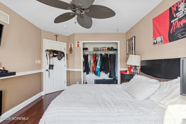 bedroom featuring a closet, dark hardwood / wood-style flooring, and ceiling fan