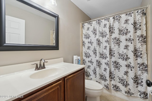 bathroom with toilet, vanity, and a shower with curtain