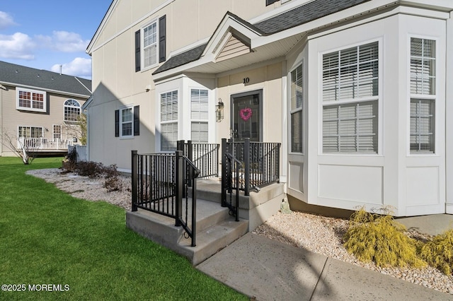 view of exterior entry featuring a yard