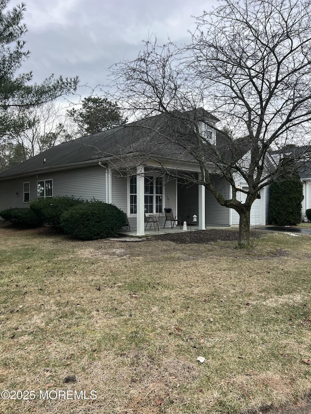 view of front of house with a patio area and a front yard