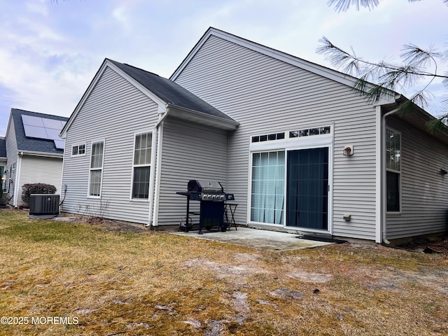 back of property featuring central AC unit, a yard, and a patio area