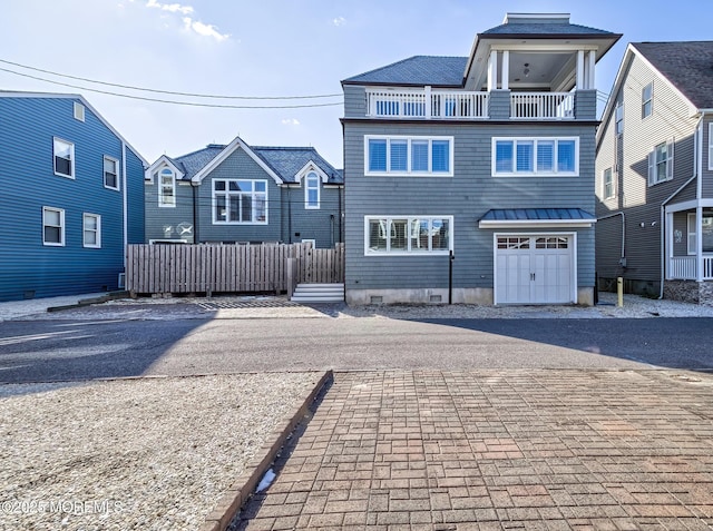 front facade featuring a balcony and a garage