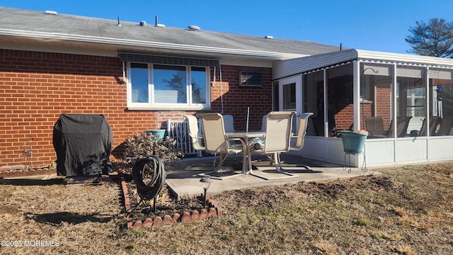 back of property featuring a patio area and a sunroom