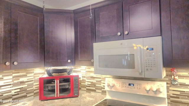 kitchen with range and backsplash