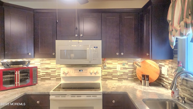 kitchen with sink, white appliances, tasteful backsplash, and light stone countertops