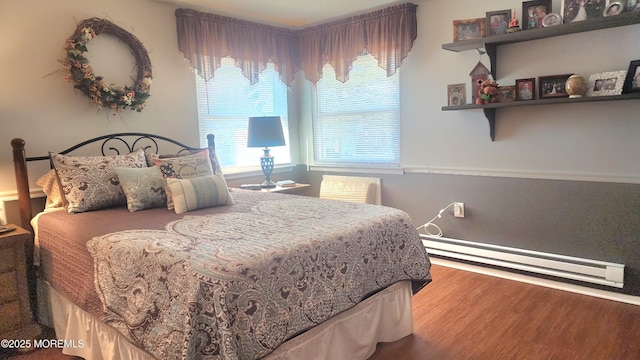 bedroom featuring baseboard heating and wood-type flooring