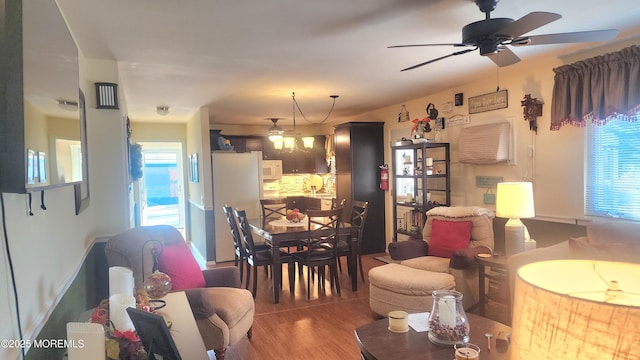 living room with ceiling fan and dark hardwood / wood-style flooring