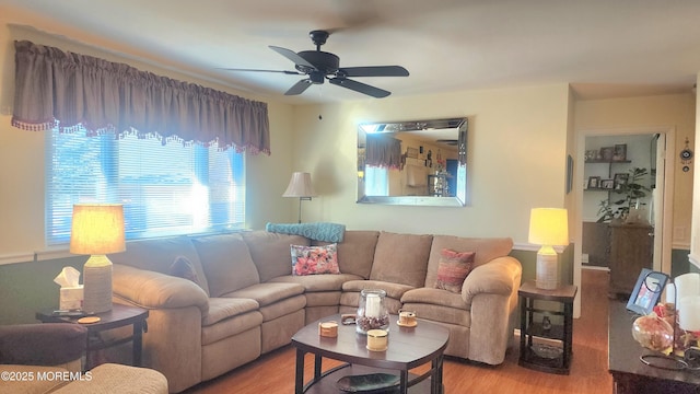 living room featuring light wood-type flooring and ceiling fan