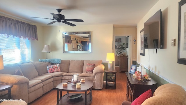 living room featuring ceiling fan and hardwood / wood-style flooring