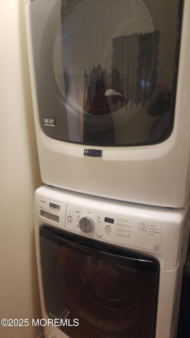 laundry room featuring stacked washer and dryer