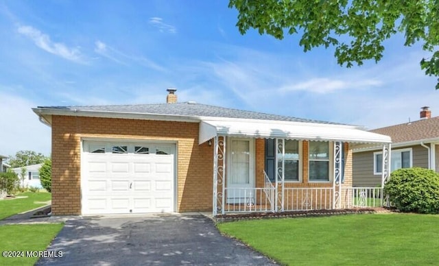 ranch-style house with a front yard, a porch, and a garage