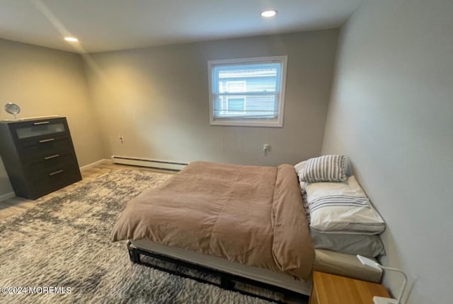 bedroom featuring a baseboard radiator and light wood-type flooring