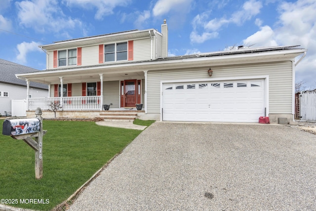 view of front of home featuring covered porch, solar panels, a garage, and a front lawn